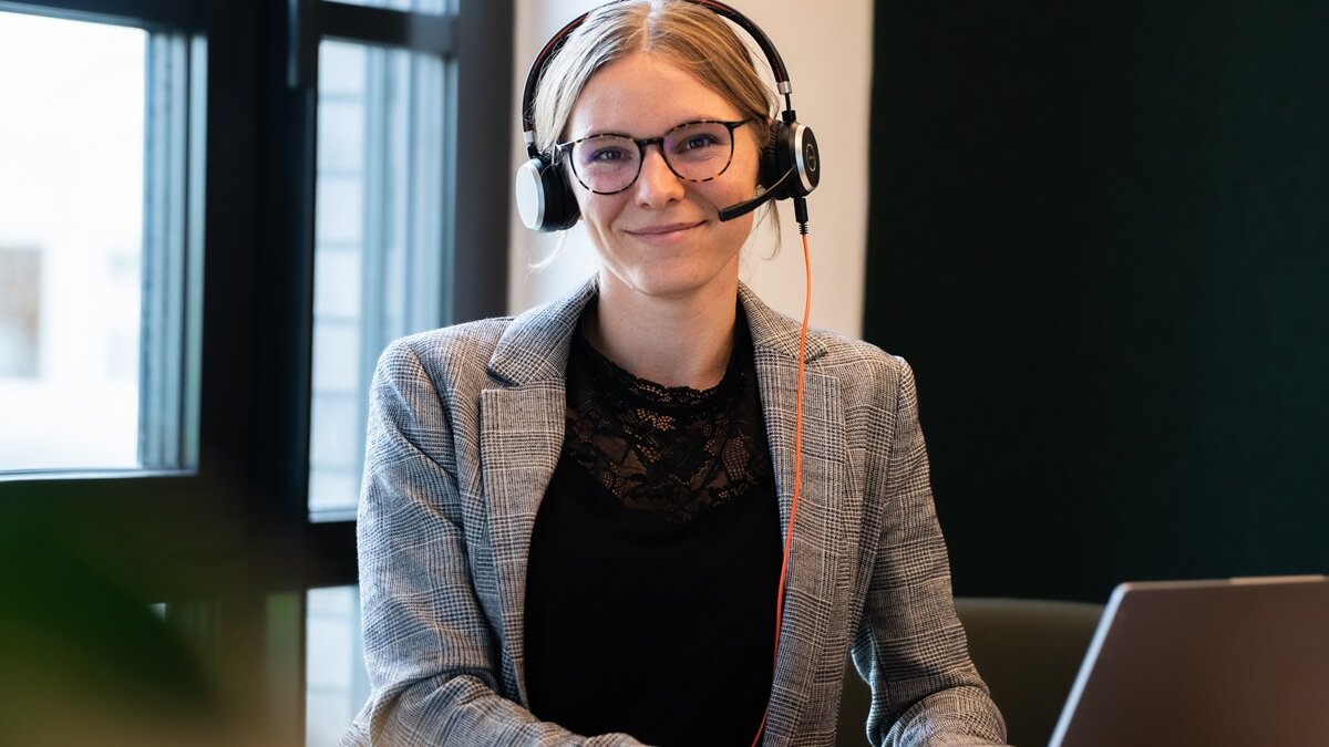 lingoking employee with headset at laptop