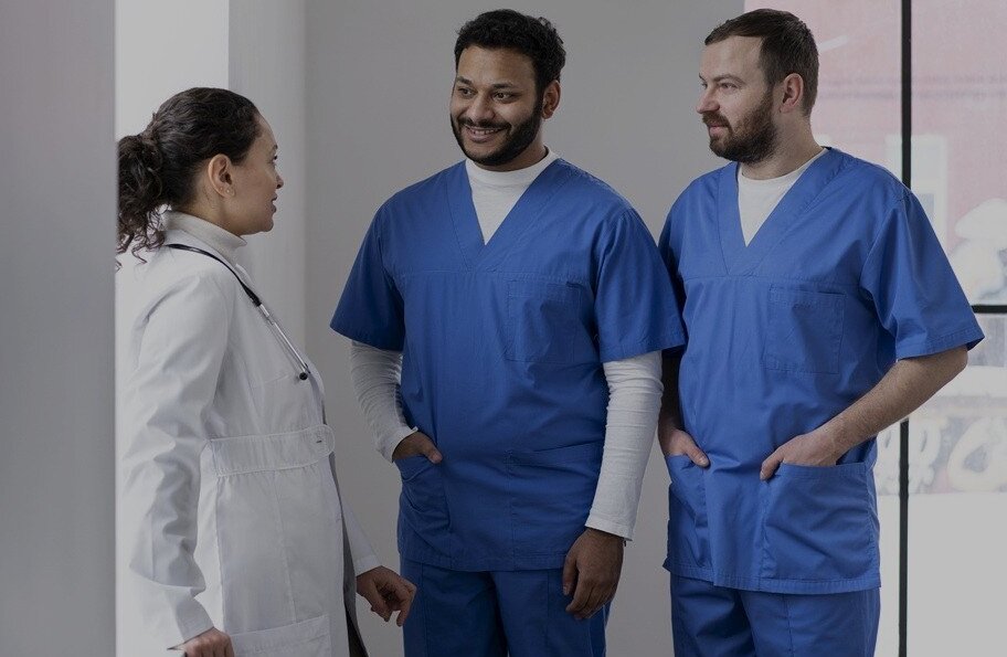 Two young international nursing trainees with a doctor