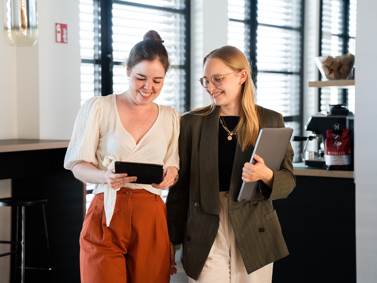 Two lingoking employees looking into tablet