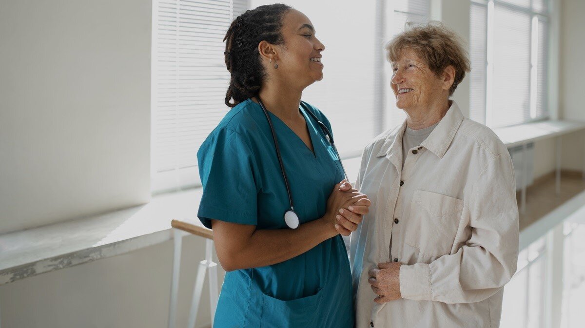 Nurse from abroad with elderly woman