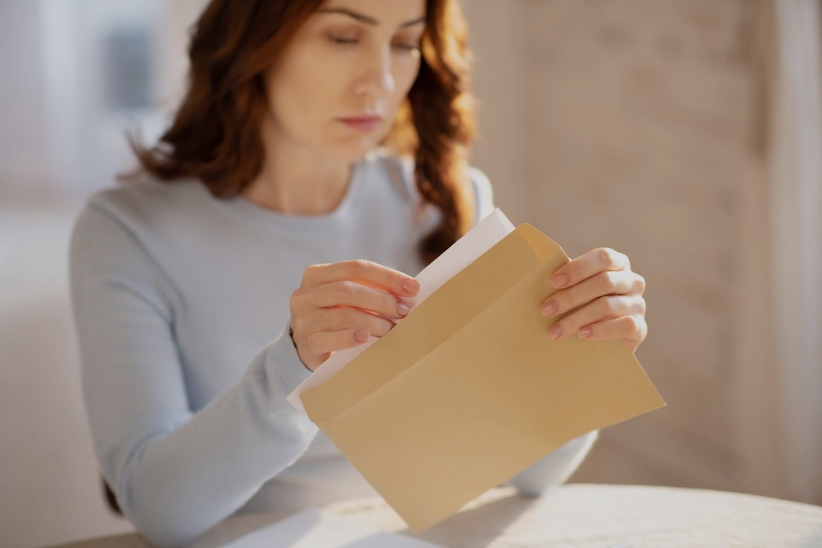 Woman opening letter