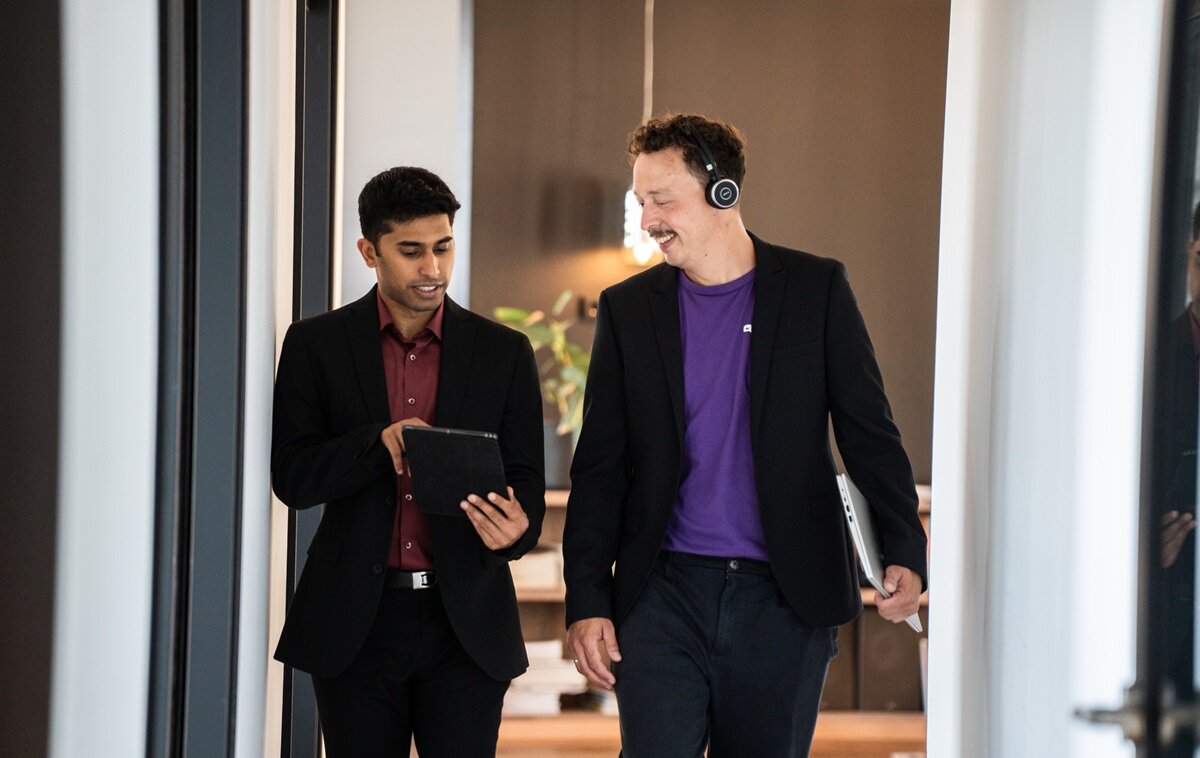 One person showing another something on tablet