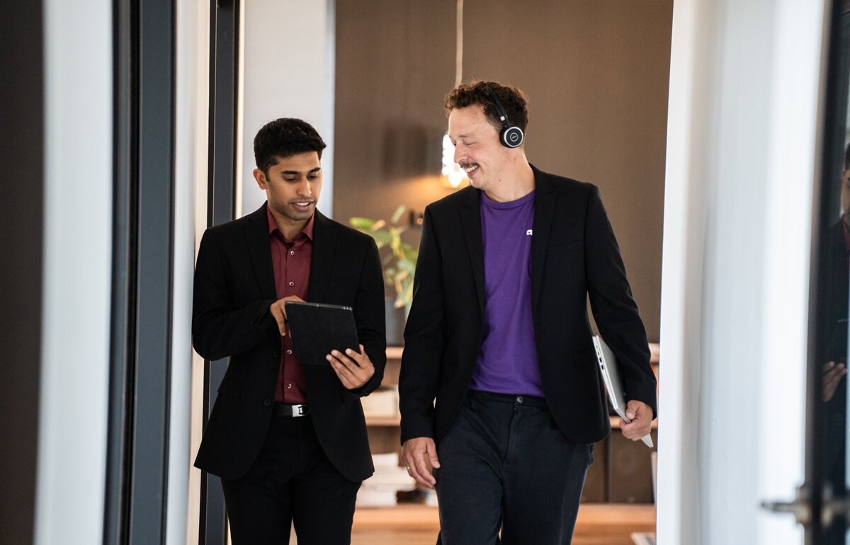 One person showing another something on tablet