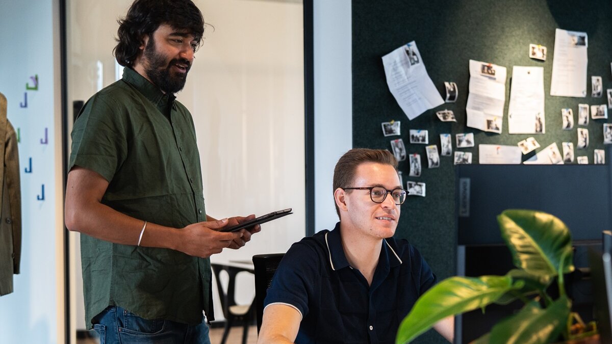 Two lingoking employees working at computer