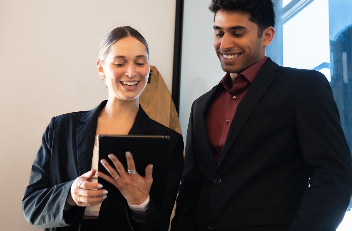 Two people looking at tablet