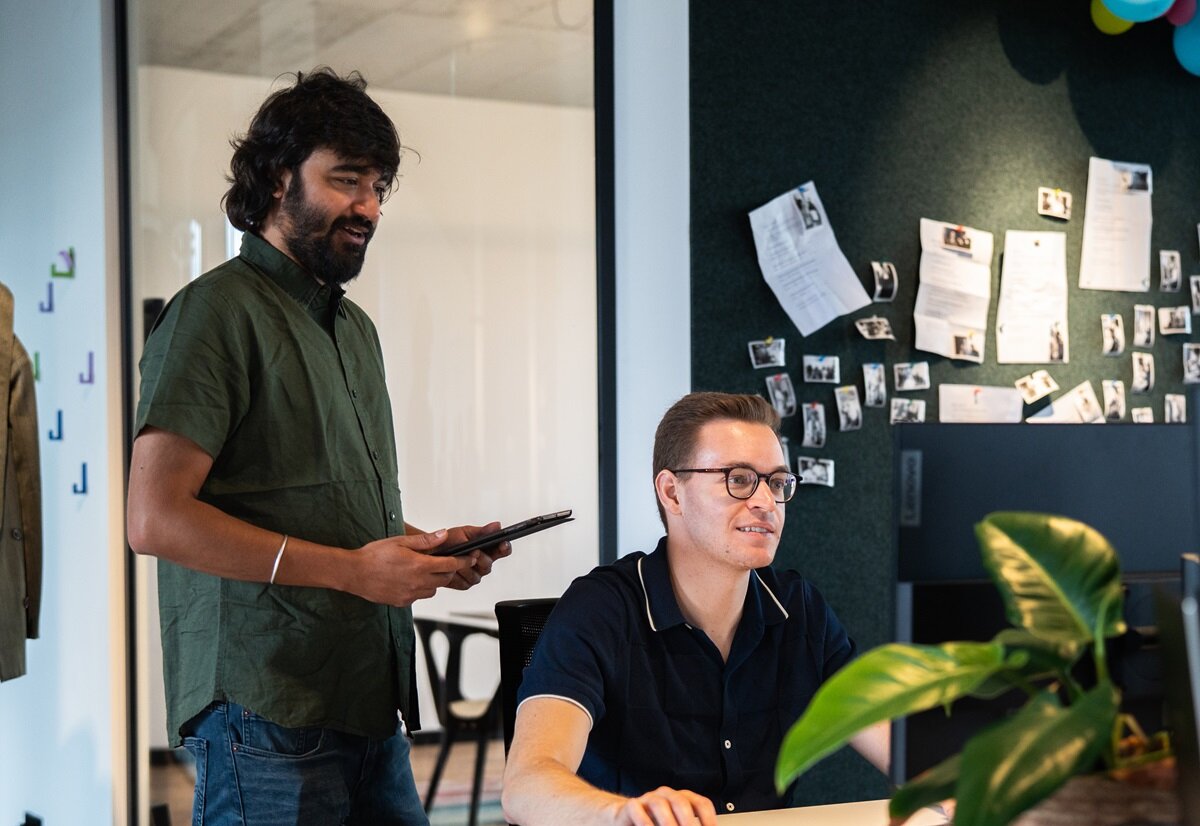 Two lingoking employess at laptop