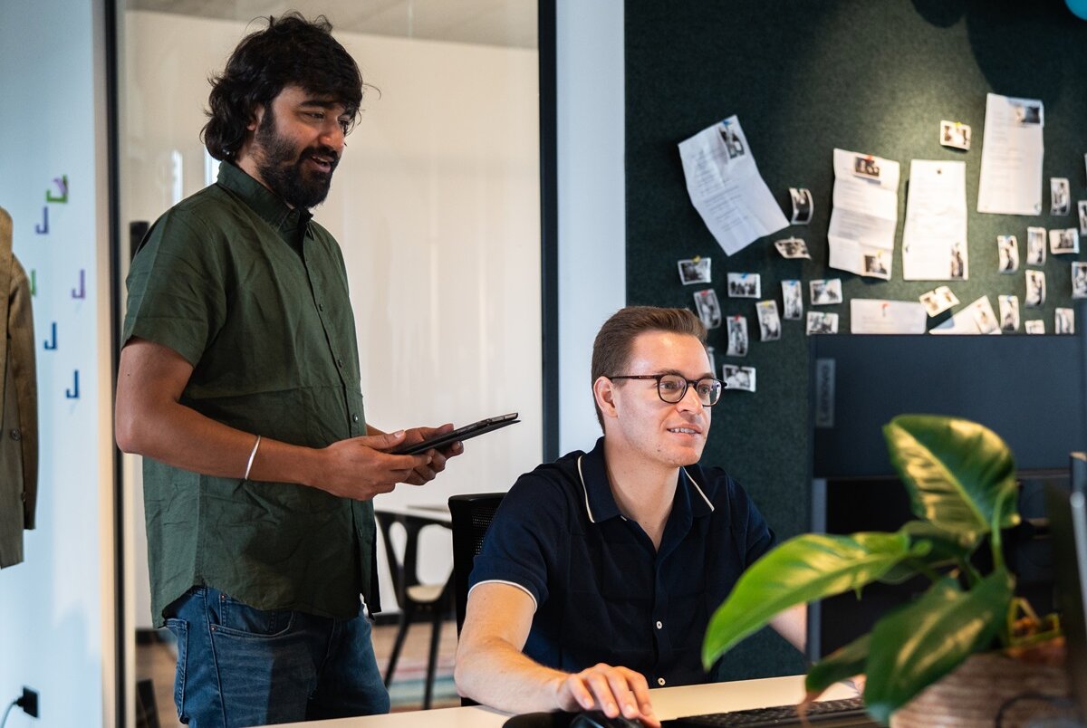 Two people looking into a pc