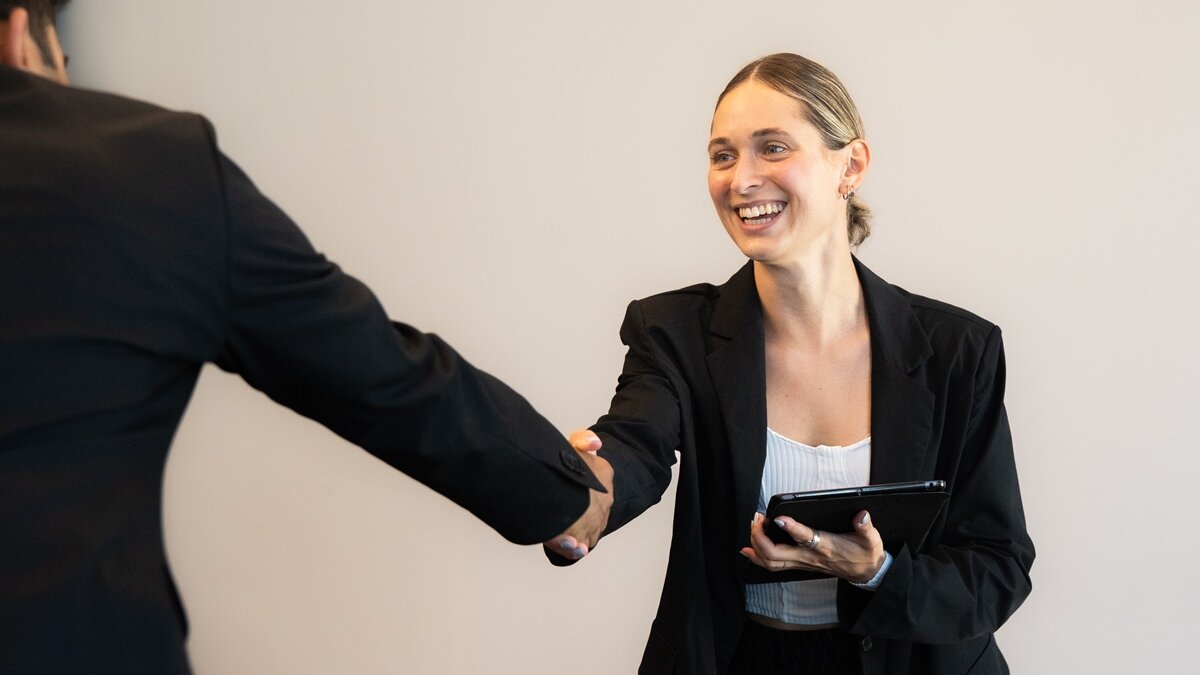 Woman shaking hand of man